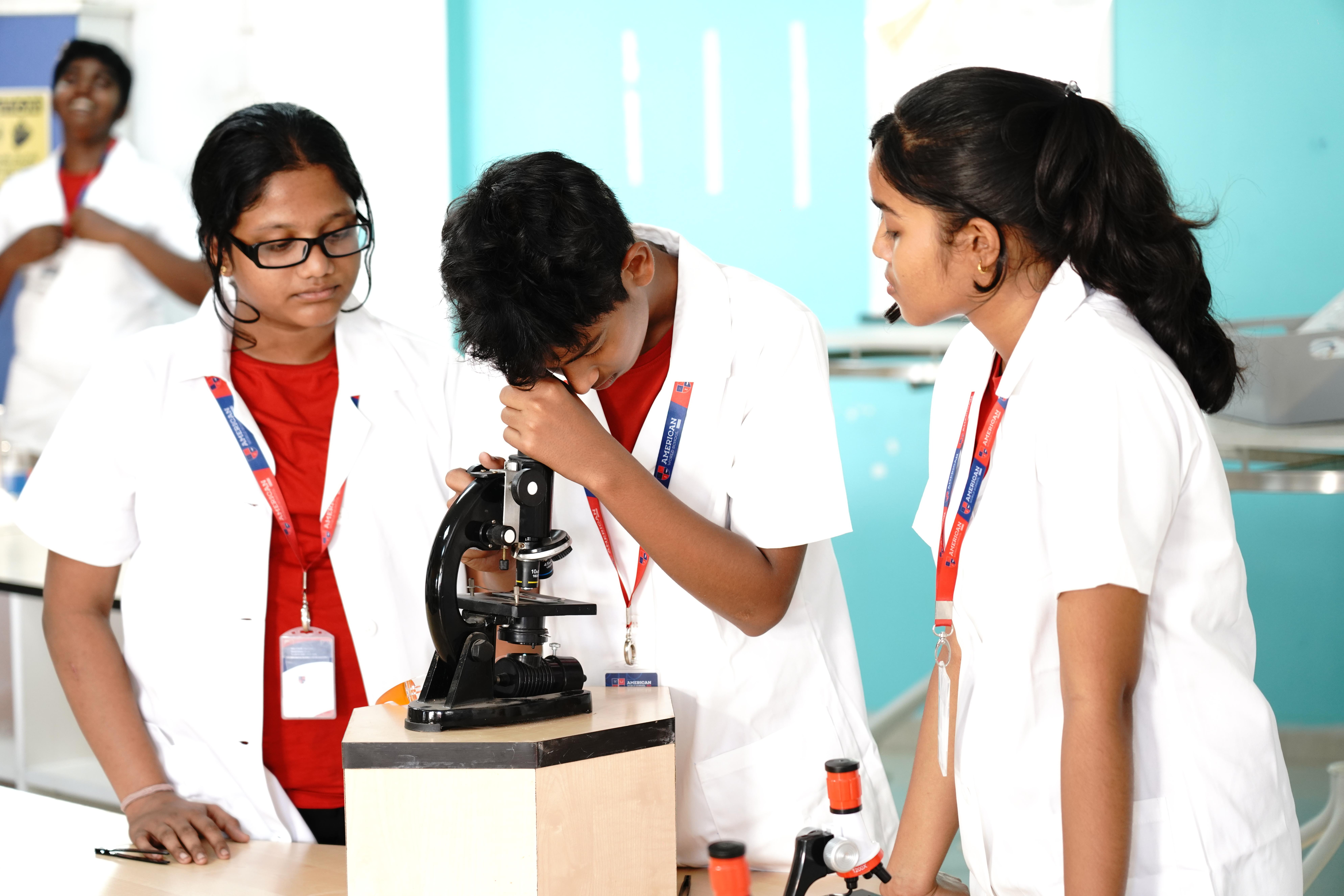 AWS students using microscope in lab